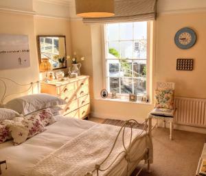 a bedroom with two beds and a window at The Old Post Office in Salcombe
