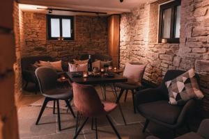 a restaurant with tables and chairs and a brick wall at Boutique-Hotel Anno 1910 in Wernigerode