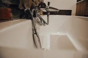 a faucet on top of a white sink at Suite Sur Le Mont in Durbuy