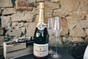 a bottle of champagne sitting next to a wine glass at Suite Sur Le Mont in Durbuy
