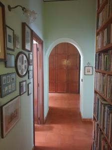 a hallway with a door and some books at La casa di Chicca in Turin