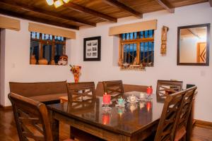 a dining room with a wooden table and chairs at Alpa Kamaska Casa Hospedaje in Nuevo Tingo