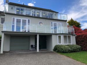 a large white house with a large balcony at Greengables B&B in Queenstown