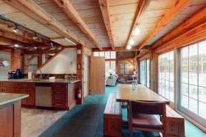 a kitchen with wooden ceilings and a table and chairs at Winhall Wonder in French Hollow