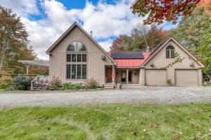 a large house with a garage and a driveway at Winhall Wonder in French Hollow