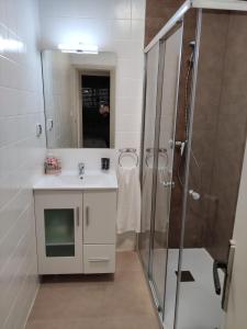 a bathroom with a sink and a shower at Casa El Callejo de La Fregeneda in La Fregeneda