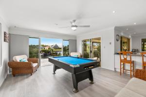 a living room with a pool table in it at Bribie Island Canal Holiday Destination! in Bongaree