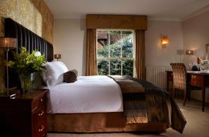 a bedroom with a large bed and a window at Lainston House in Winchester