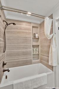 什里夫波特的住宿－Lakefront Fully Loaded Apartment，浴室配有白色浴缸和毛巾。