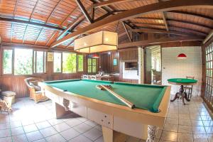 a room with a pool table in a house at Pousada Rosa in Praia do Rosa