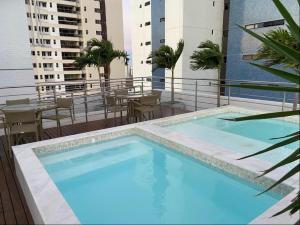 a large swimming pool on the roof of a building at Manaíra Apart Hotel in João Pessoa