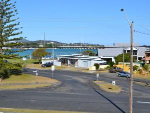 an empty street in a town with a body of water at Anchorage 10 in Tuncurry