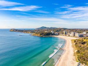 an aerial view of a beach with buildings and the ocean at Anchorage 10 in Tuncurry