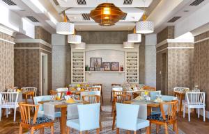 a rendering of a dining room with tables and chairs at Grand Park Lara Hotel in Lara +37 photos