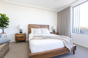 1 dormitorio con cama y ventana en Dune Beachfront Apartments by Kingscliff Accommodation, en Kingscliff