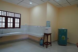 een grote badkamer met een wastafel en een koelkast bij Green Haven Holiday Home in Anuradhapura