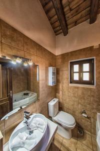 a bathroom with a sink and a toilet and a tub at Mega Lithari Corfu Luxury Villas in Kavvadádes