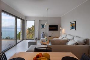 a living room with a couch and a table at Kechria Bay Villas in Skiathos