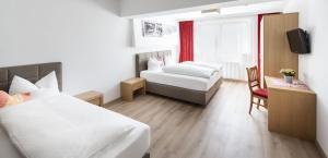 Posteľ alebo postele v izbe v ubytovaní Hotel Neuwirt