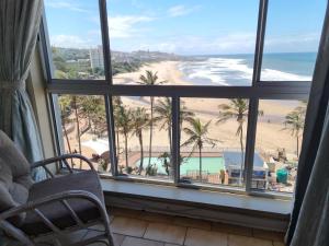 a room with a view of a beach and the ocean at Seabrook In-house Holiday Rentals in Margate