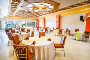 a banquet hall with white tables and chairs at Hotel Valencia in Valencia