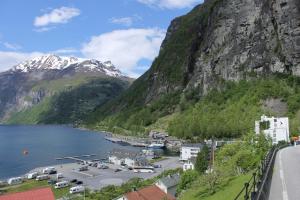 a view of a town in front of a mountain at Havila Hotel Geiranger in Geiranger