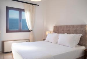 A bed or beds in a room at Aegean Blue Horizon