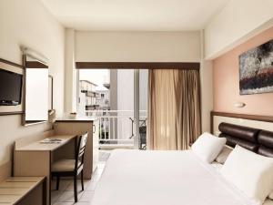 Ένα ή περισσότερα κρεβάτια σε δωμάτιο στο Pearl Hotel