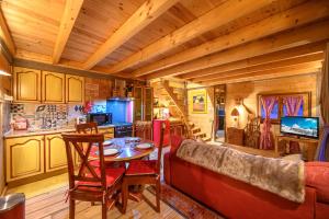 a living room with a red couch and a table at Petit Rochebrune in Orcières