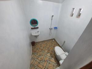 a bathroom with a toilet and a sink at Rinjani Camp Sajank in Sajang