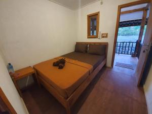 a bedroom with a bed with a teddy bear on it at Rinjani Camp Sajank in Sajang