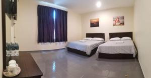 Postel nebo postele na pokoji v ubytování Hotel Pangkor SJ + 20 fotografií