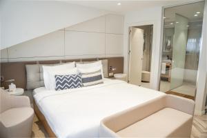a bedroom with a large white bed and a bathroom at Stayso by Cloud7 Hotels in Istanbul