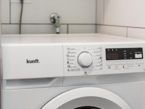 a washing machine with the words kmt on it at 651 Bright establishment, heated pool and Wi Fi in Los Cristianos