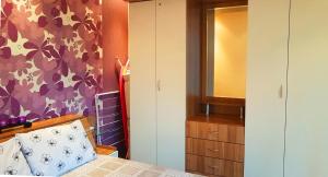 a bedroom with a bed and a dresser and a mirror at Apartment Nicole in Plovdiv