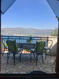 a patio with a table and chairs on a balcony at Apartment in Karin Gornji with sea view, balcony, air conditioning, Wi-Fi (4207-2) in Obrovac