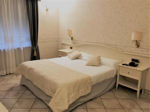 Postel nebo postele na pokoji v ubytování Hotel La Noce