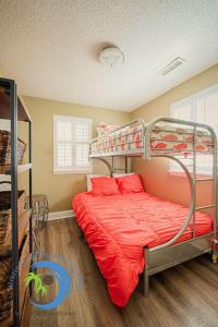 a bedroom with a bunk bed with red sheets at Windy Hill Villa 1 - Beach Barnacle in Myrtle Beach