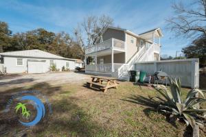 a house with a picnic table in the yard at Sandcastle Down in Myrtle Beach