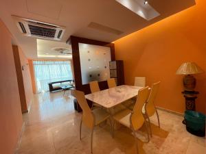 a dining room with a table and chairs at GLORY BEACH RESORT NICE SEAVIEW HIGH STANDARD 3 BEDROOM in Port Dickson