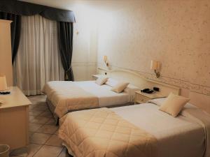 Postel nebo postele na pokoji v ubytování Hotel La Noce