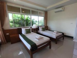 Postel nebo postele na pokoji v ubytování Mountain Resort Koh Lipe