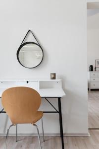 a desk with a mirror and a chair at Sophienne Apartments in Vienna