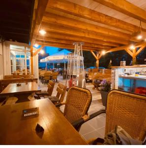 a restaurant with wooden tables and chairs at Hotel Diele in Detmold