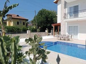 a villa with a swimming pool and a house at Fabulous 3 bedroom Apartment in Dalyan with pool in Dalyan