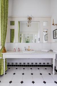 a bathroom with a sink and a mirror at Vila Austerlitz in Slavkov u Brna