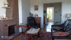 a living room with a couch and a fireplace at Le Flaugergues in Rodez