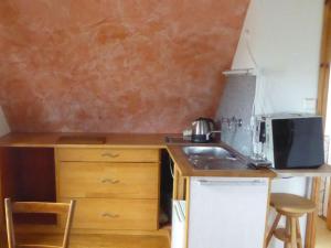 a small kitchen with a sink and a microwave at Das blaue Haus in Pfullendorf