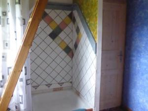 a staircase in a room with a tiled wall at Das blaue Haus in Pfullendorf