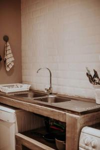 a kitchen with a sink and a counter top at Sorgenfri in Hendrina +34 photos
